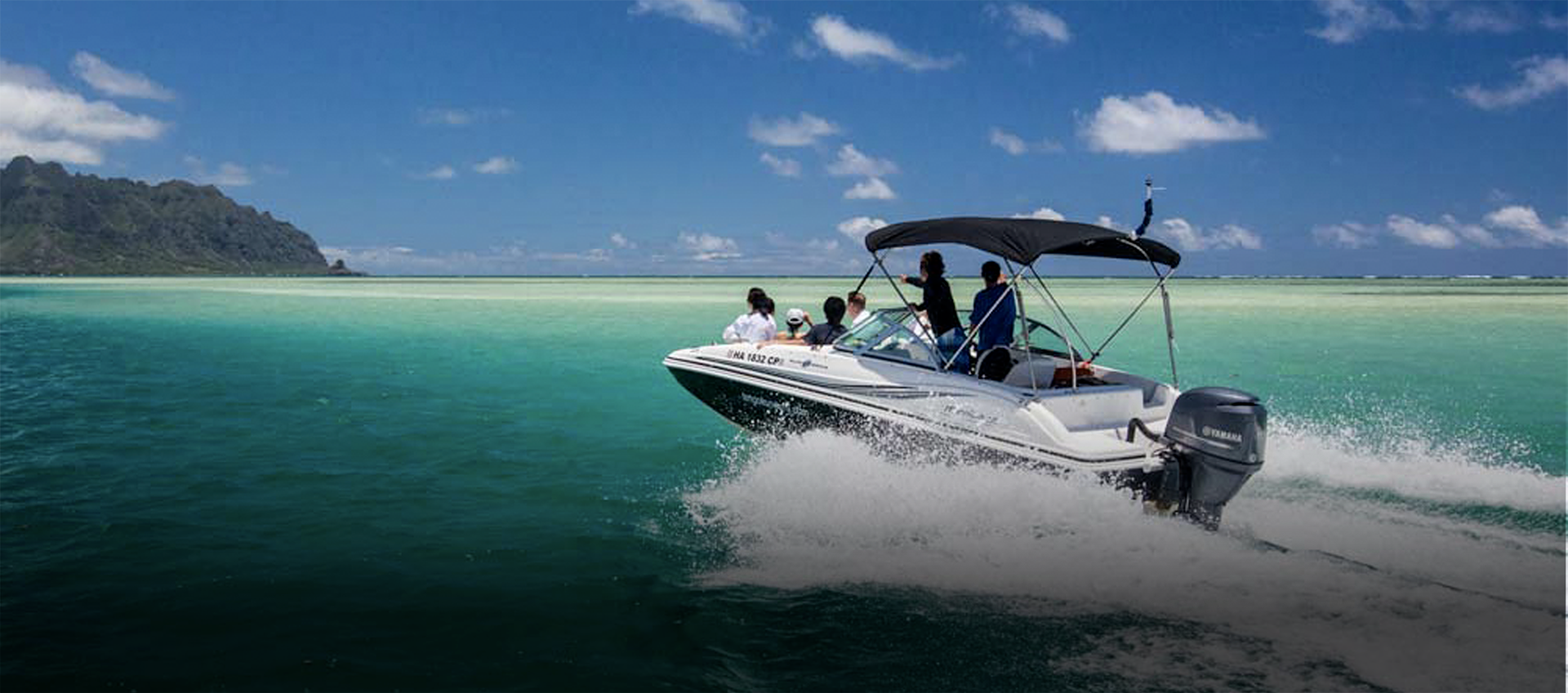 A group of passengers on a boat in the ocean.